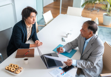 Corporate financial advisor reviewing accounting reports in modern Dubai office