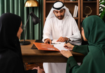 Corporate consultant reviewing immigration and business documents in modern Dubai office