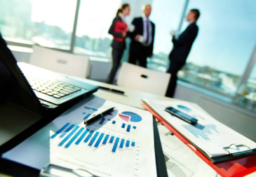 Financial professional reviewing financial reports and charts in a modern Dubai office